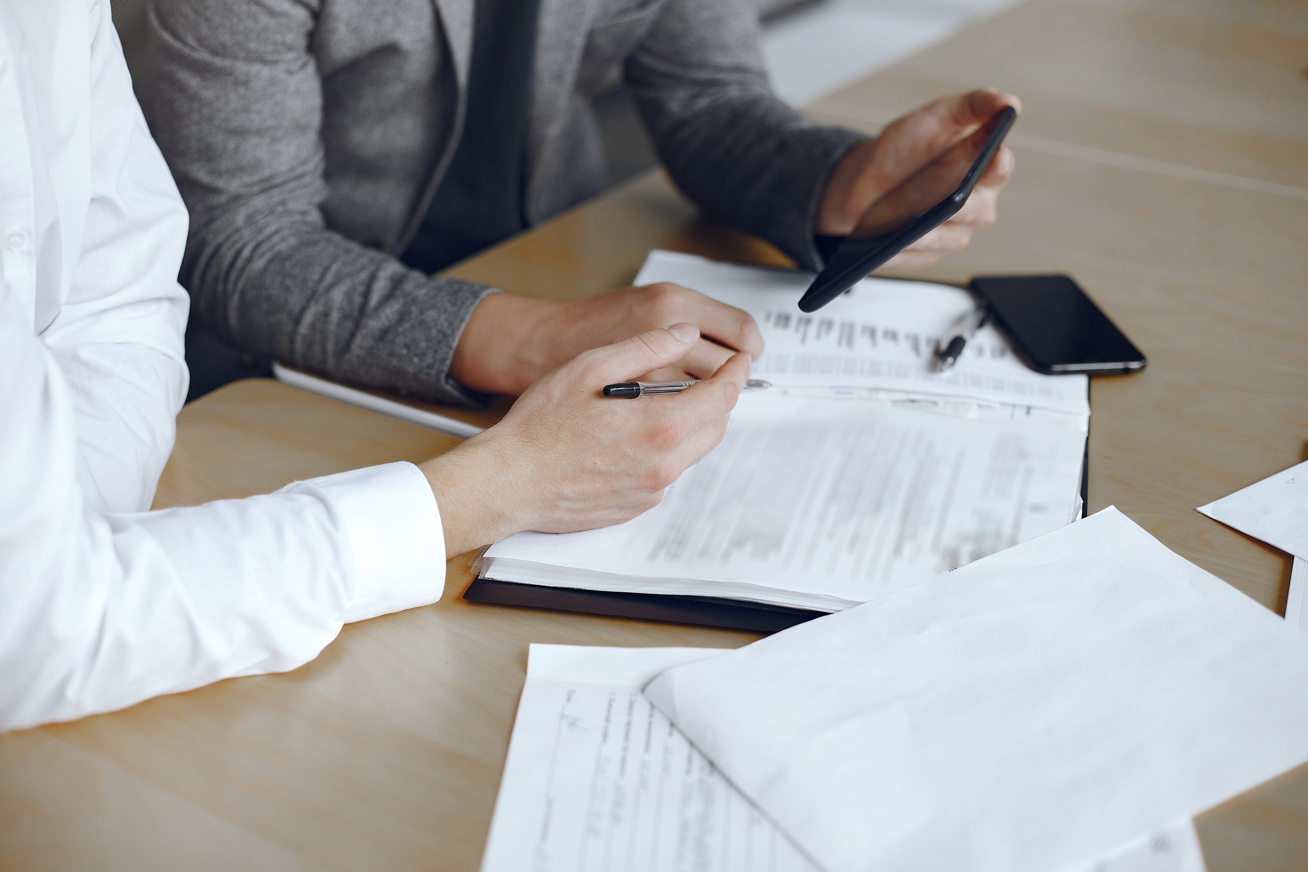 Two business partners signing a document